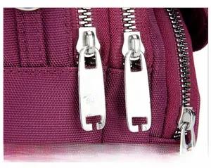 Detailed macro view of durable nylon fabric with two smooth silver metal zippers