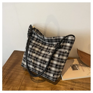 Detail of black and white checkered tote bag with bear embroidery and bow shoulder straps