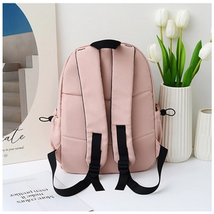 Back view of pink nylon backpack with reinforced black shoulder straps and drawstring pocket