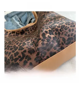 Détail de la texture du sac cabas léopard avec passepoil en cuir marron de qualité