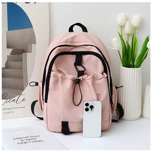 Pink nylon backpack detail showing drawstring pocket and high-quality waterproof texture