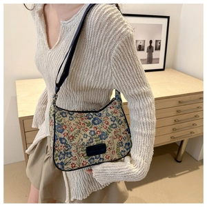 Floral jacquard shoulder bag detail showing retro flower pattern and fabric texture