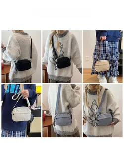 Detail view of nylon crossbody bag in various colors with adjustable shoulder strap