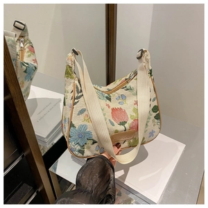 Detail of floral jacquard tote bag with leather tag and premium metal zipper closure