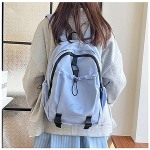 Detail view of the light blue nylon backpack with Polo Club logo and adjustable straps