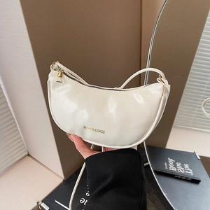 Chic beige crescent shoulder bag in PU leather with gold hardware and fashion lettering