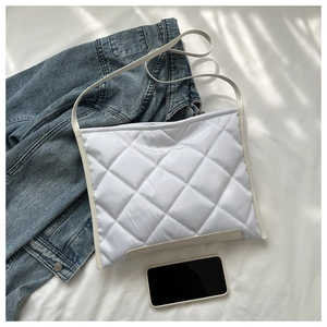 Detail view of white quilted tote bag in oxford cloth with smartphone for size reference