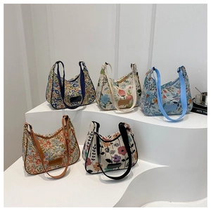 Close-up of five floral canvas shoulder bags in different retro patterns on white steps