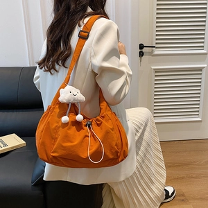 Minimalist orange nylon crossbody bag with drawstring design and cute cloud charm