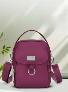Vertical nylon crossbody phone bag in purple featuring multiple zipper compartments