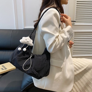 Lightweight black nylon cloud bag with white plush charm and pleated design for women