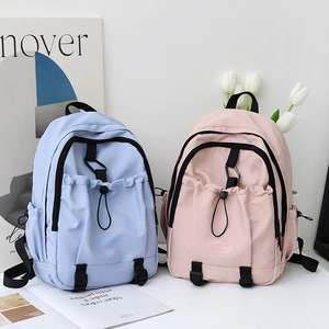 Pastel pink and light blue nylon backpacks with drawstring pockets and brand logo