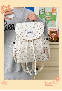 Detailed close-up of corduroy backpack with cute bear prints and bow tie patterns