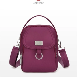 Vertical purple nylon phone crossbody bag with multi-zipper compartments and metal ring
