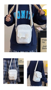 Detailed views of a white canvas crossbody bag showing the flap cover and wide strap