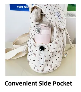 Detail view of the corduroy backpack side pocket with drawstring and pink water bottle
