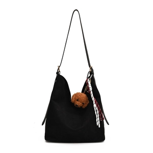 Chic black matte hobo bag with teddy charm and striped scarf accessory on white backdrop
