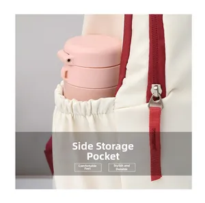 Detail of off-white travel backpack showing side elastic pocket and red zipper closure