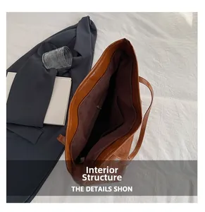 Detail view of large brown tote bag interior with zipper pocket and croc texture leather