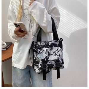 Detail of graffiti print oxford tote bag showing buckles and adjustable shoulder strap