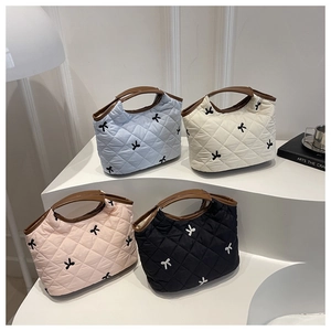 Quilted nylon handbags with bow embroidery in light blue, cream, pink, and black colors