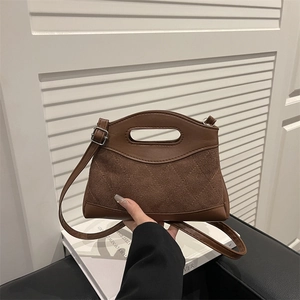 Quilted brown leather handbag with contrast textures and top handle for women