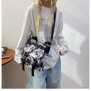 Detailed view of the street graffiti oxford bag with contrast strap and buckle closure