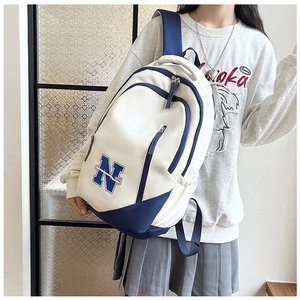 Close-up side view of the large capacity canvas backpack with blue N pattern for students