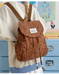 Close-up of corduroy backpack showing heart bow prints and soft ribbed texture detail