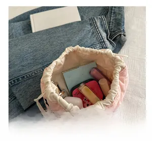 Pink quilted bucket makeup bag with drawstring closure showing large storage capacity