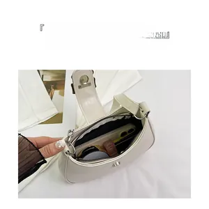Detail view of large capacity hobo bag interior showing smartphone and makeup storage