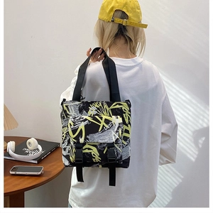 Detail of trendy color-block Oxford tote bag with buckle pockets in street style