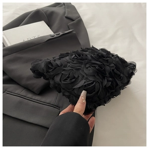 Detailed view of black 3D rose petal evening bag with light organza fabric texture