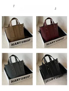 Detail view of lychee leather tote bags in khaki, wine red, grey, and black colors