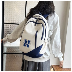 Detail view of stylish white and blue college style backpack with large capacity storage