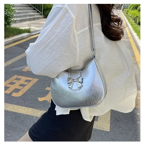 Silver metallic hobo bag with a 3D metal bow detail and shoulder strap for women