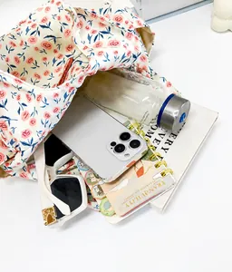Top view of floral bento tote bag showing large capacity with phone, bottle and sunglasses