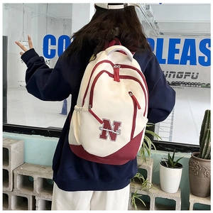 Detail view of stylish college style backpack with letter N logo and contrast color design