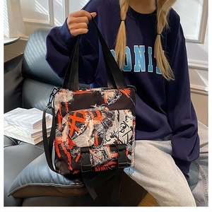 Detail of the street style graffiti tote bag showing buckle pocket and adjustable strap