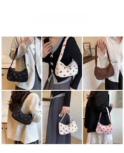 Detailed views of corduroy underarm bags with red strawberry print in multiple colors