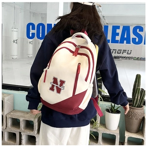 Macro detail of breathable mesh straps and color-block design on the large travel backpack