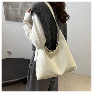 Dettaglio di una grande borsa hobo color crema con trama in morbida ecopelle