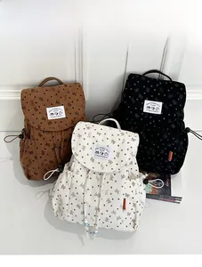 Detailed corduroy backpacks with bow prints in brown, black, and beige colors