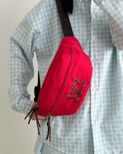 Detail of red nylon crossbody chest bag with embroidery and adjustable strap