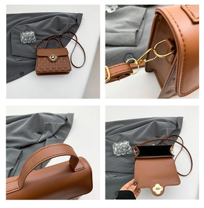 Macro detail of the golden clover lock and stitching on this brown quilted handbag