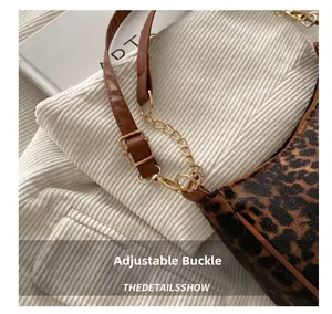 Close-up of leopard print shoulder bag with gold chain and adjustable buckle strap