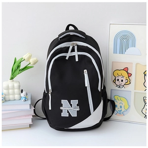 Detail of classic black and white backpack with N letter logo and durable nylon fabric