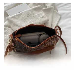 Detailed interior view showing large storage capacity of the leopard print crescent bag