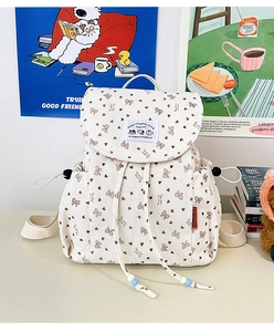 Close-up of beige corduroy backpack texture with cute cat and heart prints