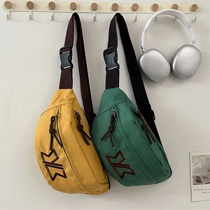 Minimalist canvas chest bags in yellow and green with adjustable shoulder straps